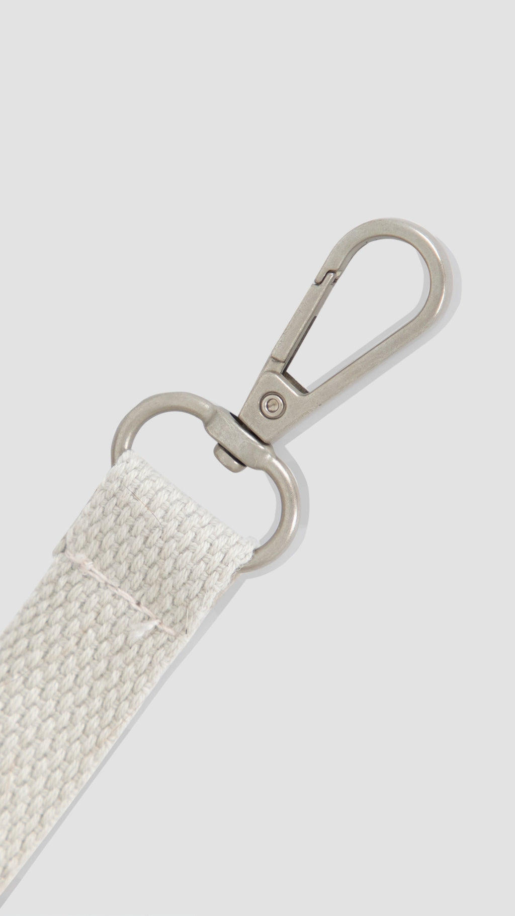 A close-up of a white woven strap attached to a silver metal swivel clasp, shown against a light gray background.