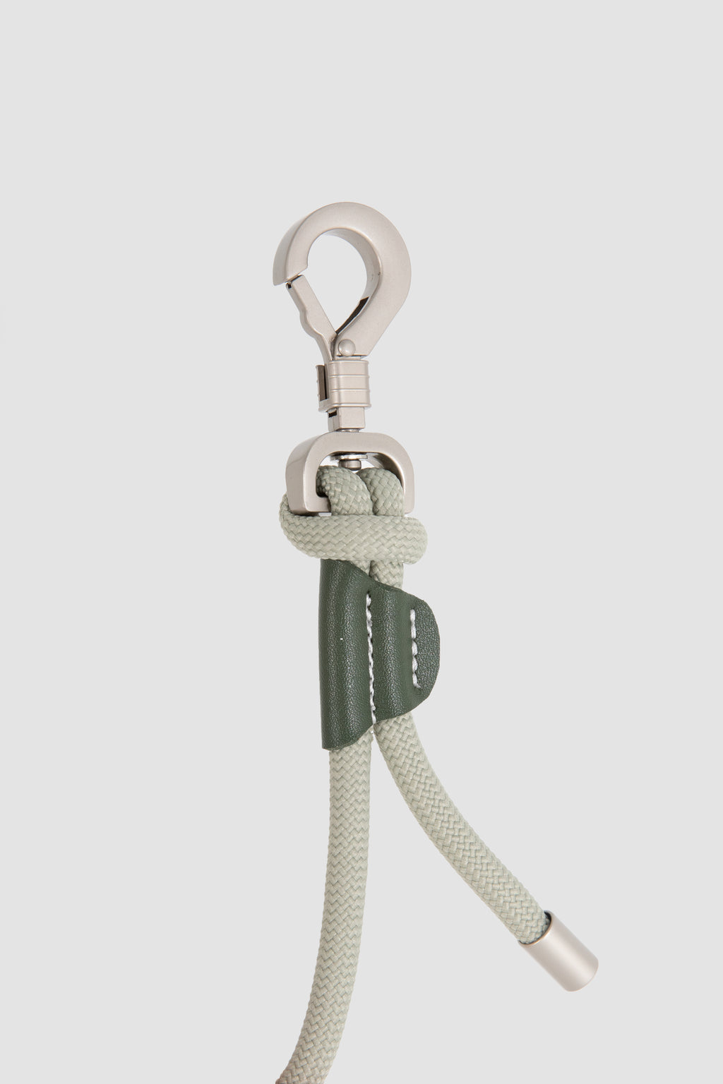 Buckle with rope and metal clip on a light gray background