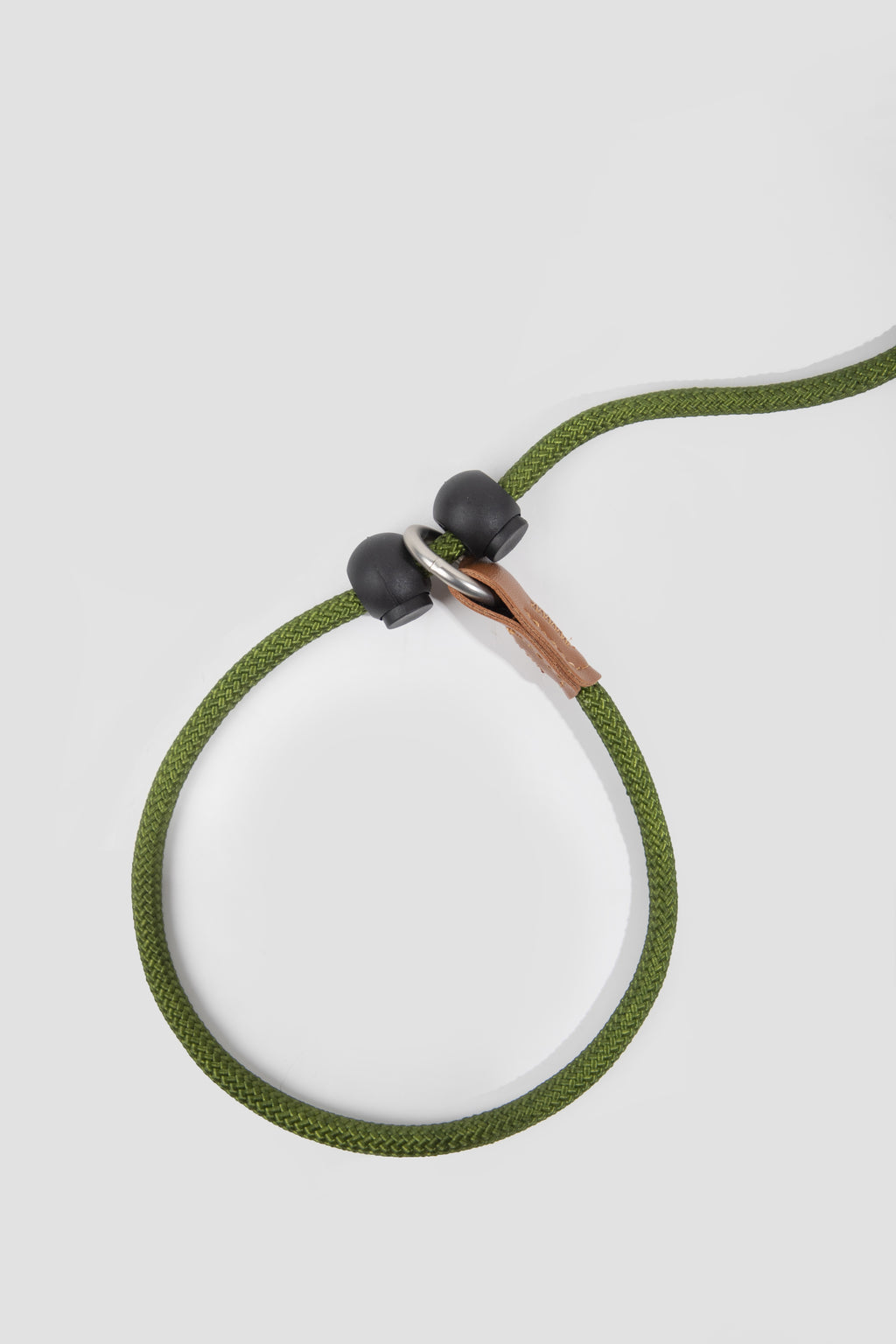 Green necklace with black beads on a light gray background