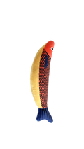 A fish-shaped plush toy with a red-orange head, a red-and-black patterned body, and a blue tail, shown on a plain white background.
