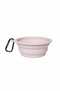A light pink collapsible silicone pet bowl with a black carabiner clip on the side, shown on a plain white background.