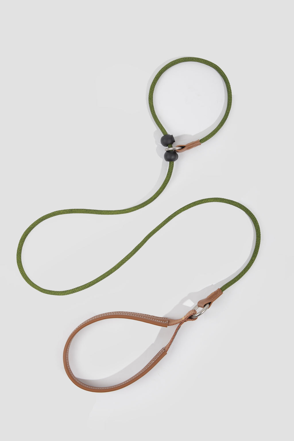 Green and brown dog leash on a light gray background