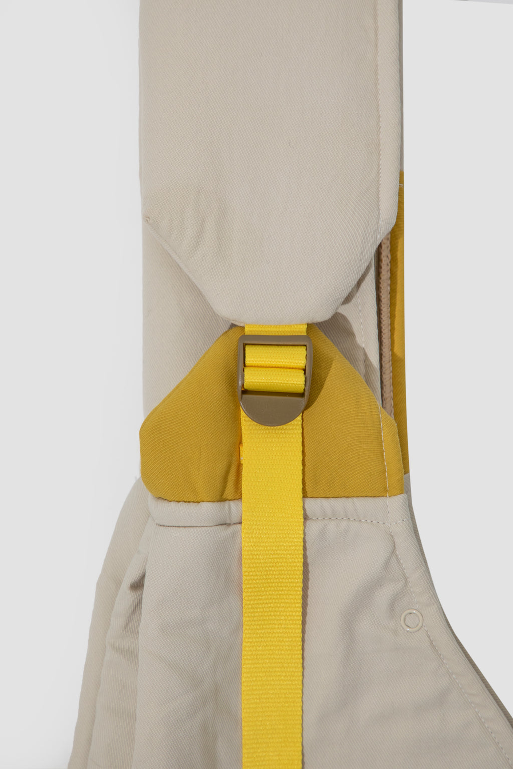 Beige overalls with a yellow strap on a white background